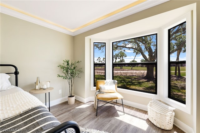 bedroom with ornamental molding and light hardwood / wood-style floors