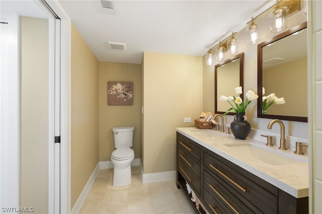 bathroom featuring toilet, tile flooring, dual sinks, and oversized vanity