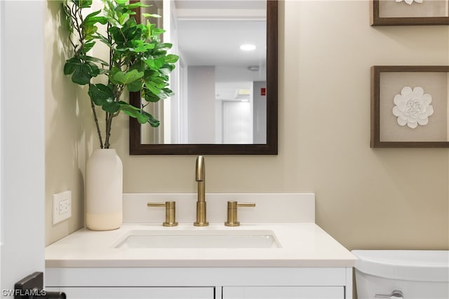 bathroom with large vanity and toilet