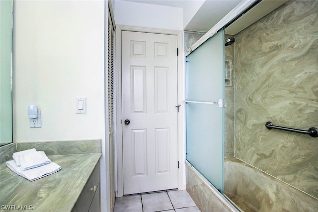 bathroom with vanity, combined bath / shower with glass door, and tile flooring