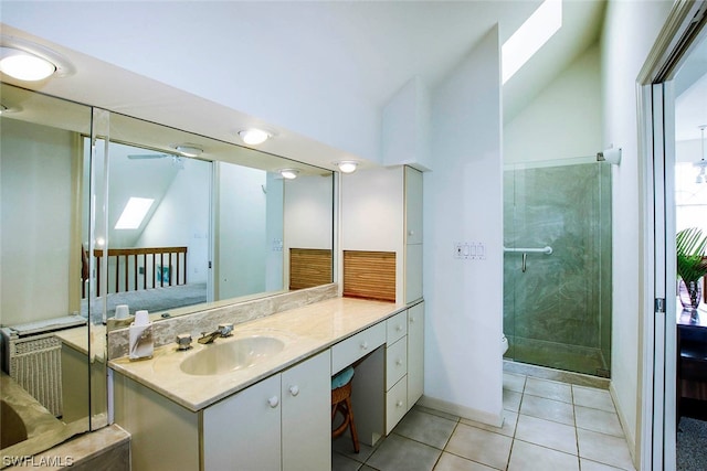 bathroom featuring lofted ceiling, tile flooring, large vanity, and ceiling fan