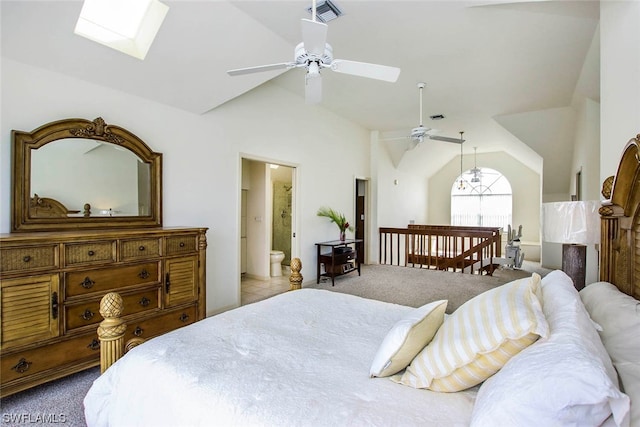 carpeted bedroom featuring high vaulted ceiling, ensuite bath, ceiling fan, and a skylight