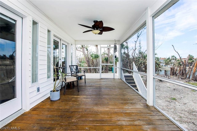 sunroom / solarium with french doors and ceiling fan