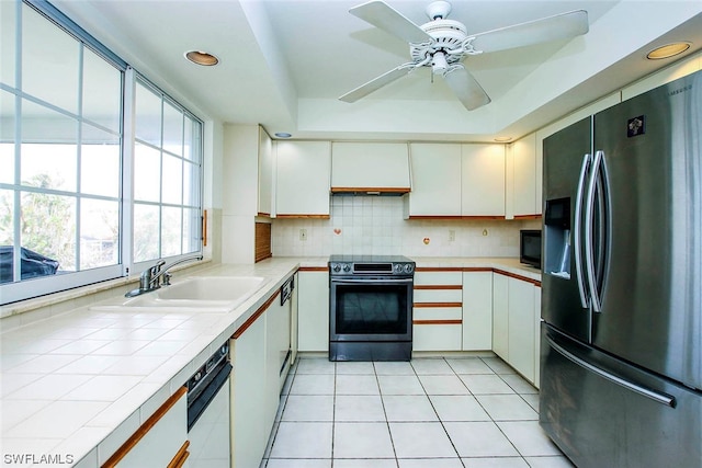 kitchen featuring white cabinetry, ceiling fan, electric range, stainless steel fridge, and tasteful backsplash