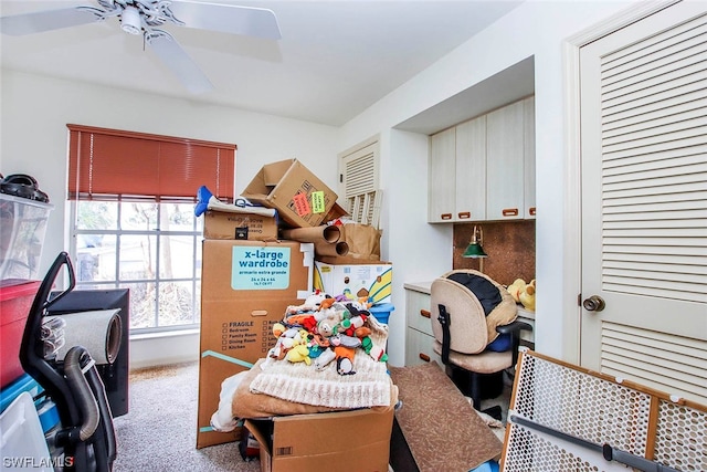 interior space featuring ceiling fan and light colored carpet