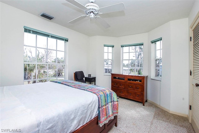 carpeted bedroom featuring a closet and ceiling fan