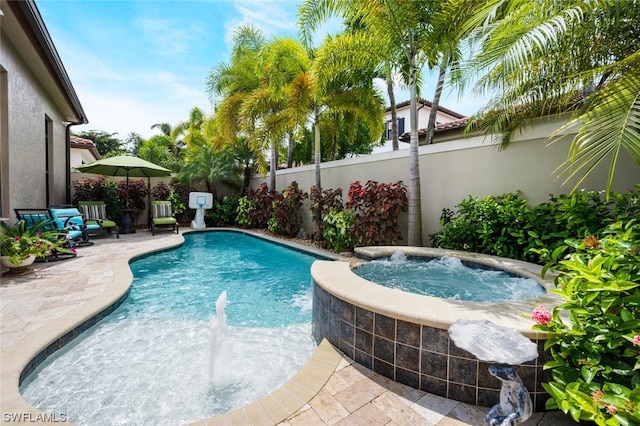 view of swimming pool featuring an in ground hot tub and a patio area