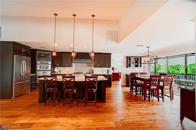 interior space with an inviting chandelier and light hardwood / wood-style flooring