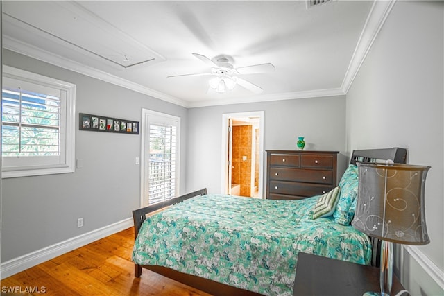 bedroom with crown molding, hardwood / wood-style floors, ceiling fan, and multiple windows