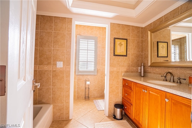 bathroom featuring tile floors, tile walls, a tray ceiling, and ornamental molding