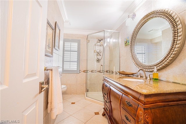 bathroom featuring vanity, tile floors, toilet, a shower with shower door, and ornamental molding