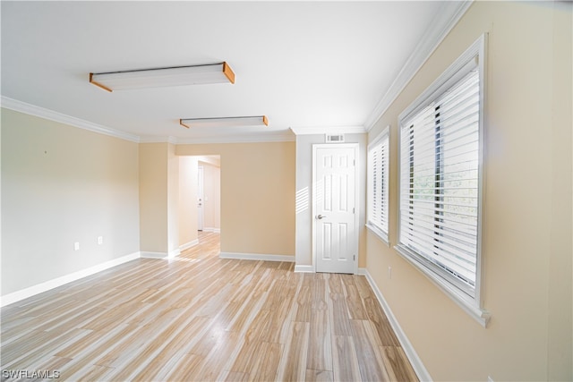 unfurnished room featuring light hardwood / wood-style flooring and crown molding