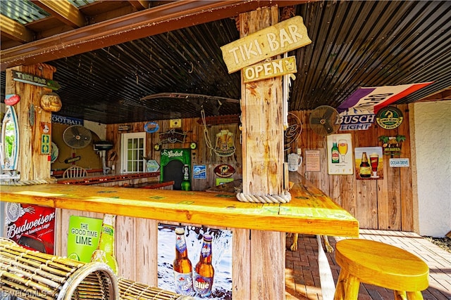 exterior space featuring wood walls and bar area