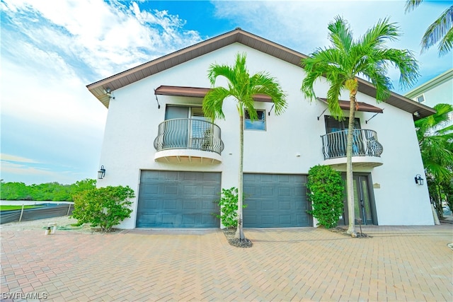 view of front of home featuring a balcony and a garage