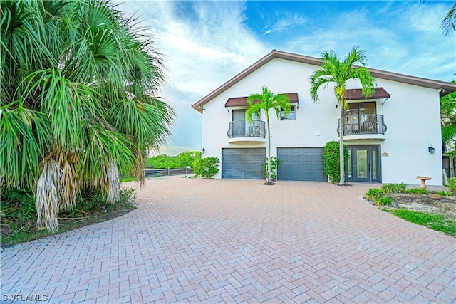 view of front of property with a balcony and a garage