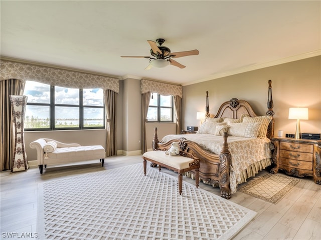 bedroom with ornamental molding, ceiling fan, and light wood-type flooring