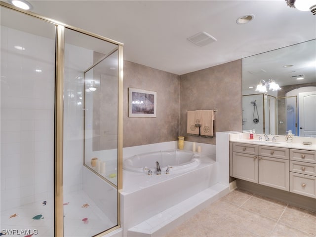 bathroom featuring vanity, shower with separate bathtub, and tile patterned flooring