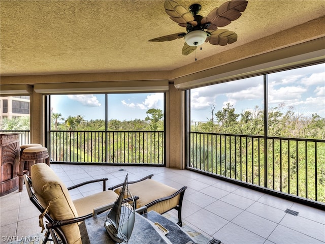 sunroom featuring ceiling fan