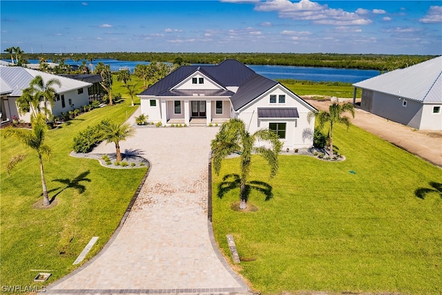 view of front facade featuring a front yard and a water view