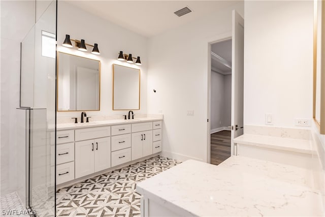 bathroom featuring tile flooring, plus walk in shower, oversized vanity, and dual sinks