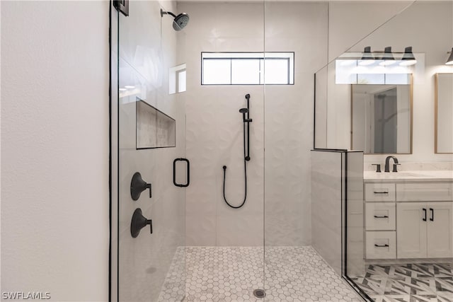 bathroom with a shower with door and large vanity