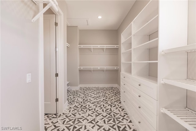 spacious closet featuring light tile flooring