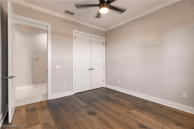 unfurnished bedroom with ceiling fan, a closet, hardwood / wood-style flooring, and crown molding