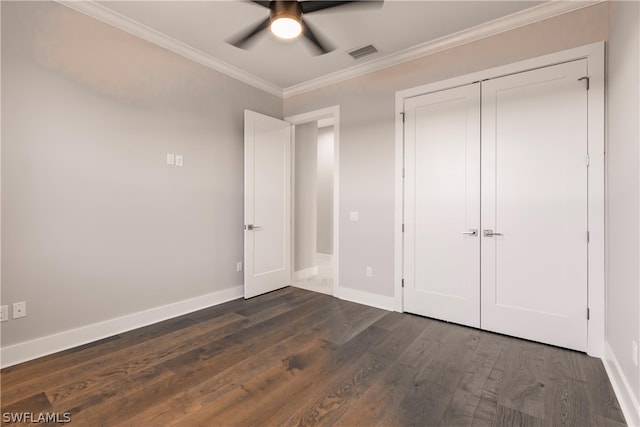 unfurnished bedroom with crown molding, a closet, ceiling fan, and dark hardwood / wood-style flooring