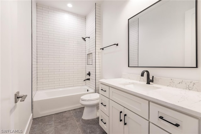 full bathroom featuring tile flooring, tiled shower / bath combo, vanity, and toilet