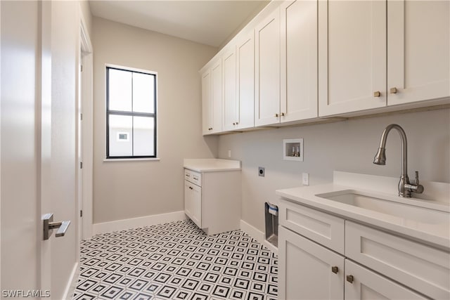 clothes washing area with cabinets, hookup for a washing machine, sink, light tile floors, and hookup for an electric dryer