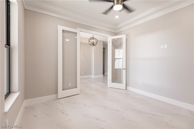 tiled spare room with ceiling fan and a raised ceiling