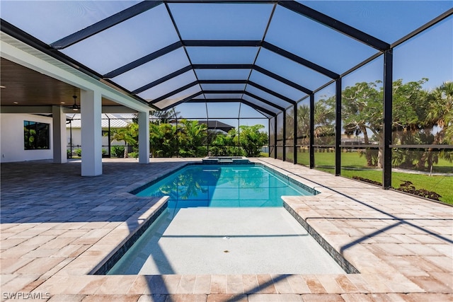 view of swimming pool featuring a lanai and a patio area