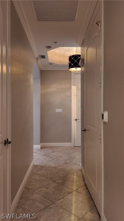 hallway featuring a raised ceiling and crown molding