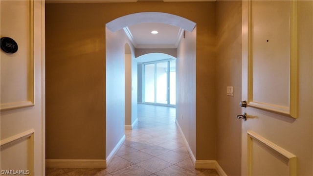 hall featuring ornamental molding and light tile patterned floors