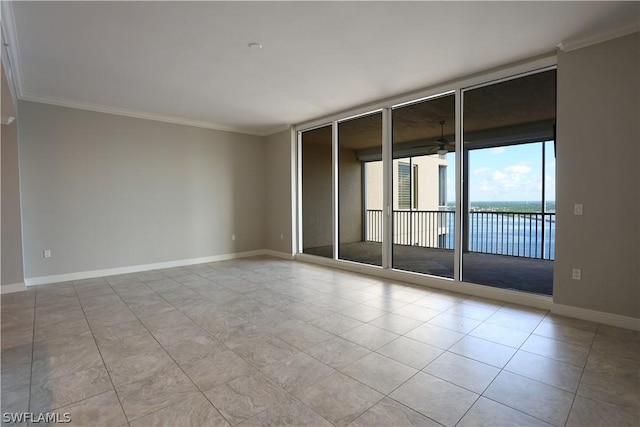 empty room with ornamental molding, a water view, ceiling fan, and a wall of windows