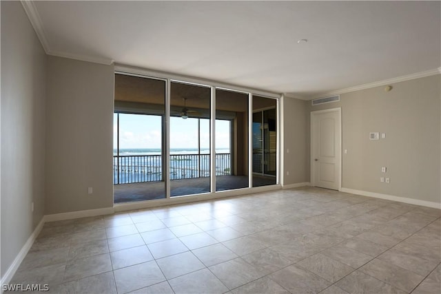 spare room with crown molding, a wall of windows, ceiling fan, and a water view