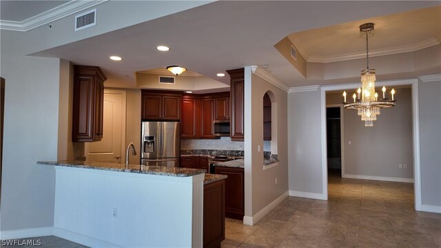 kitchen featuring tile patterned flooring, dark stone countertops, kitchen peninsula, backsplash, and appliances with stainless steel finishes