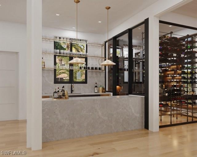 wine room featuring hardwood / wood-style floors and indoor bar