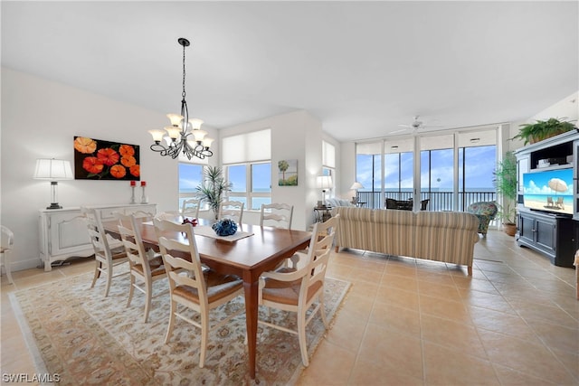 dining room featuring light tile floors, floor to ceiling windows, and ceiling fan with notable chandelier