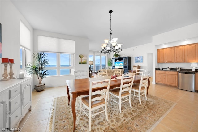 dining space featuring light tile flooring and a notable chandelier