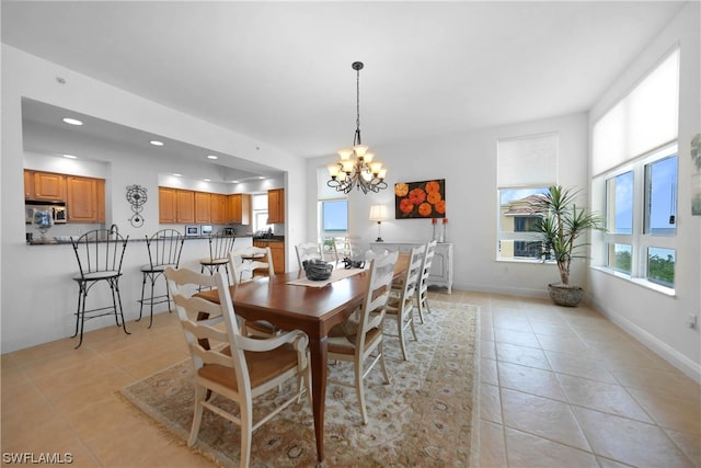 dining room with light tile floors and a chandelier