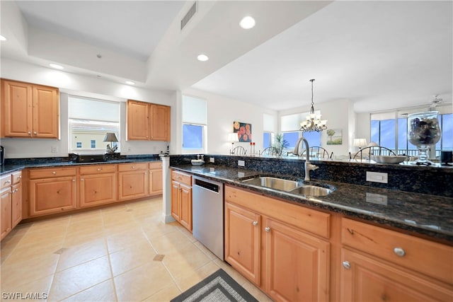 kitchen featuring plenty of natural light, sink, dishwasher, and an inviting chandelier