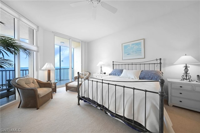 carpeted bedroom featuring access to exterior and ceiling fan