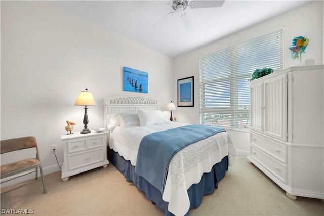 bedroom featuring light colored carpet and ceiling fan