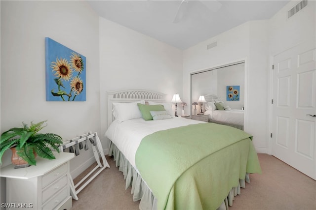 carpeted bedroom featuring a closet and ceiling fan