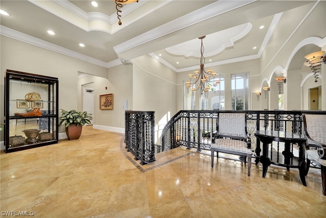 stairs featuring an inviting chandelier, crown molding, a raised ceiling, and light tile floors