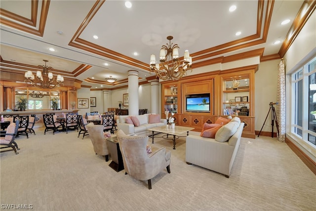 carpeted living room featuring a chandelier, a tray ceiling, decorative columns, and crown molding