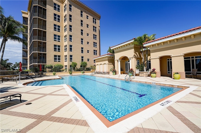 view of swimming pool featuring a patio area