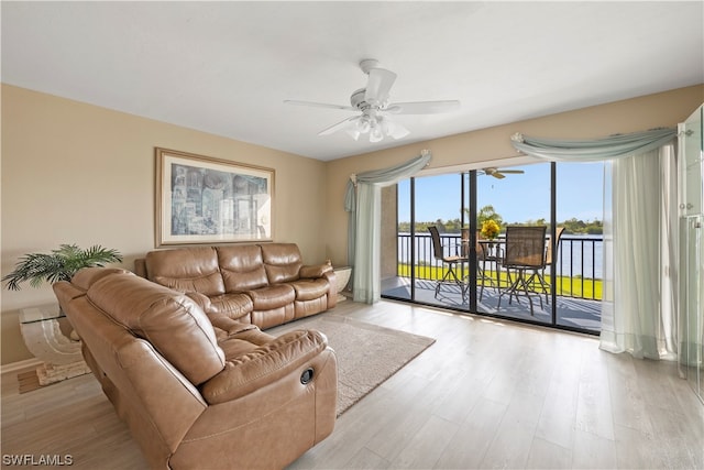 living room with light hardwood / wood-style floors and ceiling fan