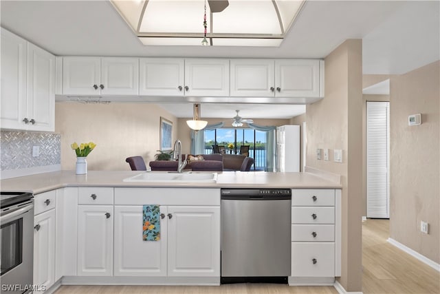 kitchen featuring white cabinetry, ceiling fan, sink, light wood-type flooring, and stainless steel appliances